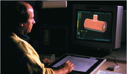 Engineer in Geneva, Switzerland, using computer-aided design (CAD) software to design a pipe junction. (Reproduced by permission of Photo Researchers, Inc.)