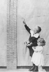 STANDARDIZATION IS CRUCIAL TO MAINTAINING STABILITY IN A SOCIETY. DURING THE GERMAN INFLATIONARY CRISIS OF THE 1920S, HYPERINFLATION LED TO AN ECONOMIC DEPRESSION AND THE RISE OF ADOLF HITLER. HERE, TWO CHILDREN GAZE UP AT A STACK OF 100,000 GERMAN MARKS—THE EQUIVALENT AT THE TIME TO ONE U.S. DOLLAR. (© Bettmann/Corbis.)