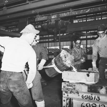 DURING WORLD WAR II, MAGNESIUM WAS HEAVILY USED IN AIRCRAFT COMPONENTS. IN THIS 1941 PHOTO, WORKERS POUR MOLTEN MAGNESIUM INTO A CAST AT THE WRIGHT AERONAUTICAL CORPORATION. (Bettmann/Corbis. Reproduced by permission.)