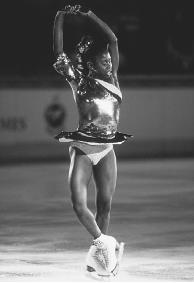 AS SURYA BONALY GOES INTO A SPIN ON THE ICE, SHE DRAWS IN HER ARMS AND LEG, REDUCING THE MOMENT OF INERTIA. BECAUSE OF THE CONSERVATION OF ANGULAR MOMENTUM, HER ANGULAR VELOCITY WILL INCREASE, MEANING THAT SHE WILL SPIN MUCH FASTER. (Bolemian Nomad Picturemakers/Corbis. Reproduced by permission.)