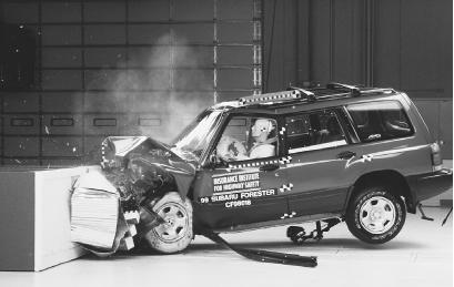 WHEN A VEHICLE HITS A WALL, AS SHOWN HERE IN A CRASH TEST, ITS MOTION WILL BE STOPPED, AND QUITE ABRUPTLY. BUT THOUGH ITS MOTION HAS STOPPED, IN THE SPLIT SECONDS AFTER THE CRASH IT IS STILL RESPONDING TO INERTIA: RATHER THAN BOUNCING OFF THE BRICK WALL, IT WILL CONTINUE PLOWING INTO IT. (Photograph by Tim Wright/Corbis. Reproduced by permission.)
