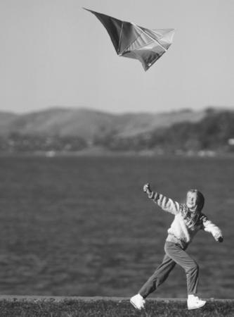 A KITE'S DESIGN, PARTICULARLY ITS USE OF LIGHTWEIGHT FABRIC STRETCHED OVER TWO CROSSED STRIPS OF VERY LIGHT WOOD, MAKES IT WELL-SUITED FOR FLIGHT, BUT WHAT KEEPS IT IN THE AIR IS A DIFFERENCE IN AIR PRESSURE. AT THE BEST POSSIBLE ANGLE OF ATTACK, THE KITE EXPERIENCES AN IDEAL RATIO OF PRESSURE FROM THE SLOWER-MOVING AIR BELOW VERSUS THE FASTER-MOVING AIR ABOVE, AND THIS GIVES IT LIFT. (Roger Ressmeyer/Corbis. Reproduced by permission.)