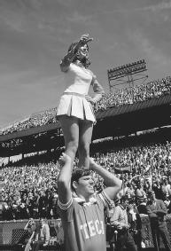 IN THE INSTANCE OF ONE CHEERLEADER STANDING ON ANOTHER'S SHOULDERS, THE CHEERLEADER'S FEET EXERT DOWNWARD PRESSURE ON HER PARTNER'S SHOULDERS. THE PRESSURE IS EQUAL TO THE GIRL'S WEIGHT DIVIDED BY THE SURFACE AREA OF HER FEET. (Photograph by James L. Amos/Corbis. Reproduced by permission.)