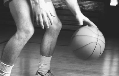 WHILE THIS PLAYER DRIBBLES HIS BASKETBALL, THE BALL EXPERIENCES A COMPLEX ENERGY TRANSFER AS IT HITS THE FLOOR AND BOUNCES BACK UP. (Photograph by David Katzenstein/Corbis. Reproduced by permission.)