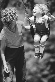 A COMMON EXAMPLE OF RESONANCE: A PARENT PUSHES HER CHILD ON A SWING. (Photograph by Annie Griffiths Belt/Corbis. Reproduced by permission.)