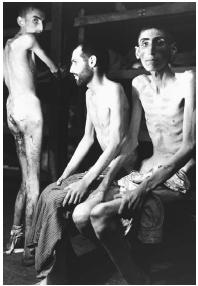 STARVING PRISONERS OF A NAZI CONCENTRATION CAMP, ONE FRIGHTENING EXAMPLE OF THE ATTEMPT TO USE GENETICS AS A FORM OF SOCIAL CONTROL. NAZI GERMANY PRACTICED MASS MURDER OF JEWS AND OTHERS WHO WERE DEEMED TO HAVE "UNDESIRABLE" TRAITS. (© Corbis. Reproduced by permission.)
