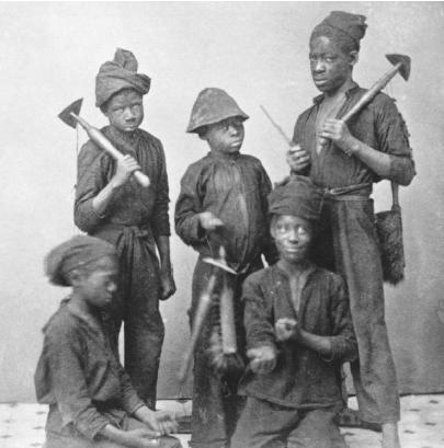PORTRAIT OF YOUNG CHIMNEY SWEEPERS FROM THE 1890S. BEFORE CHILD LABOR LAWS, BOYS AS YOUNG AS FOUR WERE PUT TO WORK CLEANING THE INSIDES OF CHIMNEYS ; MANY LATER CONTRACTED CANCER OF THE SCROTUM FROM EXPOSURE TO SOOT. (&#xA9; Bettmann/Corbis. Reproduced by permission.)