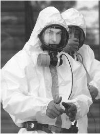 FOLLOWING THE SEPTEMBER 11, 2001, TERRORIST ATTACKS ON THE UNITED STATES, A SERIES OF LETTERS CONTAINING ANTHRAX SPORES SHOWED UP AROUND THE COUNTRY, AND EXPOSURE TO THE DISEASE LED TO A HANDFUL OF DEATHS. IN ONE INCIDENT HAZARDOUS MATERIALS EXPERTS WERE CALLED TO CAPITOL HILL TO INVESTIGATE. (© AFP/Corbis. Reproduced by permission.)