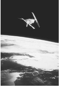 A COMMUNICATIONS SATELLITE IN ORBIT AROUND EARTH. (© ESA/Photo Researchers. Reproduced by permission.)