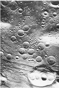 THE MOON&#x0027;S SURFACE IS POCKMARKED WITH CRATERS, SHOWING ITS VULNERABILITY TO DAMAGE CAUSED BY PARTICLES FROM SPACE. (&#xA9; NASA/Photo Researchers. Reproduced by permission.)