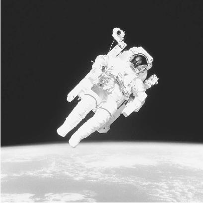 THE ASTRONAUT BRUCE MC CANDLESS FLOATS FREELY IN SPACE, OUTSIDE EARTH'S ATMOSPHERE, DURING A SHUTTLE MISSION. EARTH'S VAST INTERIOR MASS GIVES IT A STRONG GRAVITATIONAL PULL, HELPING ROOT THE PEOPLE AND MATERIALS OF OUR WORLD AND HOLDING OUR ATMOSPHERE IN PLACE. (NASA. Reproduced by permission.)