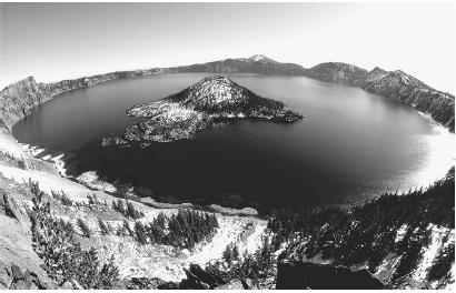 CRATER LAKE IN OREGON IS THE RESULT OF THE COLLAPSE OF A MAGMA CHAMBER AFTER A VOLCANIC ERUPTION. THIS COLLAPSE FORMS A BOWL-LIKE CRATER CALLED A CALDERA, which fills with water. (© Francois Gohier/Photo Researchers. Reproduced by permission.)