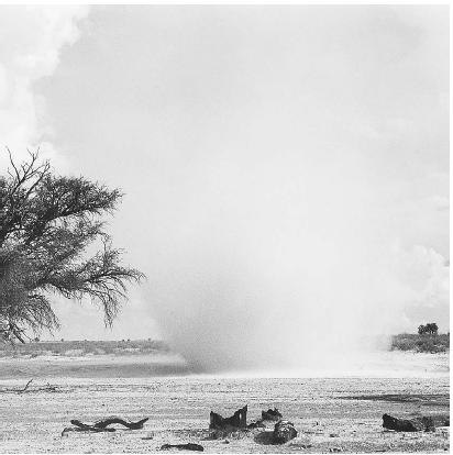 A "DUST DEVIL," OR A SMALL WHIRLWIND, CARRIES WITH IT DEBRIS AND SAND. (© Clem Haagner/Photo Researchers. Reproduced by permission.)