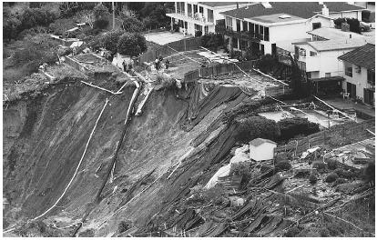 A MUDFLOW CAUSED BY HEAVY WINTER RAINS BRINGS DOWN THE HILLSIDE UNDER HOMES IN MILLBRAE, CALIFORNIA. (AP/Wide World Photos. Reproduced by permission.)