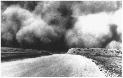 A CLOUD OF TOPSOIL IS PICKED UP BY THE WIND NEAR BOISE CITY, OKLAHOMA, DURING THE DUST BOWL OF THE 1930 S. IN SOME CASES, WIND REMOVED 3-4 IN. (7.6-10.6 CM) OF TOPSOIL, TURNING ACREAGE THAT ONCE RIPPLED WITH WHEAT INTO A DESERTLIKE WASTELAND. (AP/Wide World Photos. Reproduced by permission.)