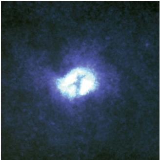 An image of the core of the Whirlpool galaxy M51 (NGC 5149) taken by the Hubble Space Telescope. It shows an immense ring of dust and gas that is thought to surround and hide a giant black hole in the center of the galaxy. (Reproduced by permission of National Aeronautics and Space Administration.)