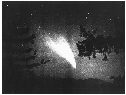Comet West above Table Mountain in California shortly before sunrise in March 1976. The comet's bright head is seen just above the mountains, while its broad dust tail sweeps up and back. (Reproduced courtesy of National Aeronautics and Space Administration.)