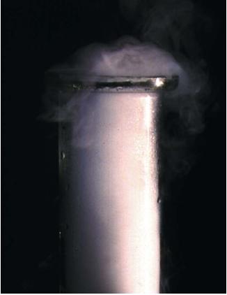 Carbon dioxide vapor diffusing from an open gas jar. The vapor molecules are traveling from the area of high concentration (the jar) to the area of low concentration (the open air). (Reproduced by permission of Photo Researchers, Inc.)