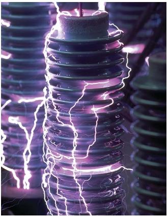 Electricity arcing over the surface of ceramic insulators. (Reproduced by permission of The Stock Market.)