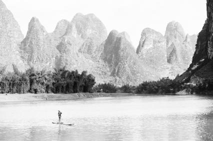 Karst topography, like that seen here along the Li River, in China, is dominated by sinkholes on the surface and extensive cave systems underneath. PHOTOGRAPH REPRODUCED BY PERMISSION OF FIELD MARK PUBLICATIONS.