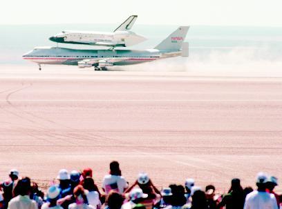 Space shuttle on the back of a 747 at Rogers Dry Lake, California. PHOTOGRAPH REPRODUCED BY PERMISSION OF THE CORBIS CORPORATION.