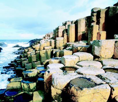 The basalt columns of Giant's Causeway on the coast of Northern Ireland. Scientists believe the strange formation was created when an ancient lava flow quickly cooled and solidified. PHOTOGRAPH REPRODUCED BY PERMISSION OF THE CORBIS CORPORATION.