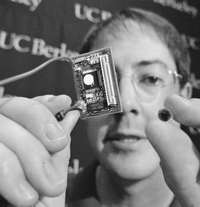 A professor at the University of California at Berkeley displays two energy-conserving smart dust sensors he invented.