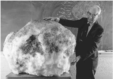 Astronomer Fred Whipple demonstrates his dirty snowball model for comets with a five-hundred-pound snowball covered with dirt.