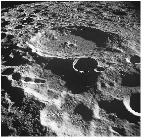 This photo of the Moon shows an amazing density of impact craters. The large crater at top-center is called Daedalus.
