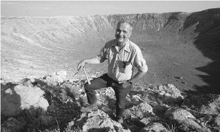 Scientist Eugene Shoemaker poses on the rim of Arizonas Barringer Crater, which formed from the impact of a metallic asteroid.