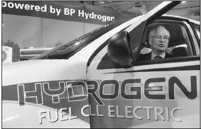 A Ford Motor Company executive demonstrates a hydrogen-fueled electric car. Hydrogen fuel cells are a promising energy alternative.