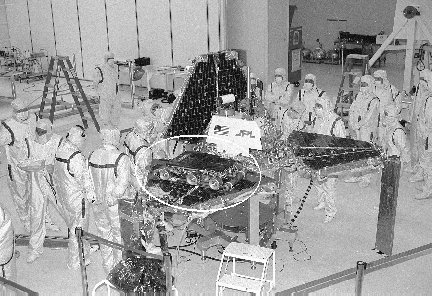 Scientists prepare the Sojourner roving robot (circled) for its mission to Mars.
