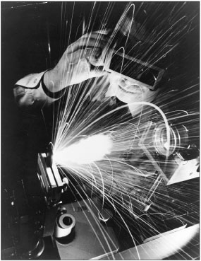 A technician uses a laser to cut holes in carbon steel, one of the hardest of all artificial substances.