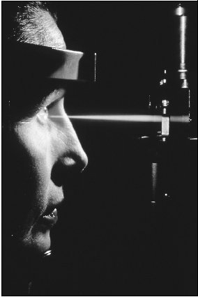 A patient undergoes eye surgery performed by a laser beam. In addition to treating detached retinas, lasers can remove cataracts.