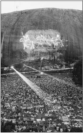 A huge crowd enjoys a laser show projected onto the granite surface of Stone Mountain near Atlanta, Georgia.
