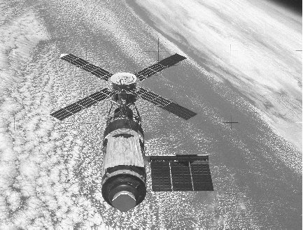 Skylab orbits Earth with the metallic parasol (bottom) that replaced the damaged micrometeoroid shield. The space station fell out of orbit in 1979 after three missions.