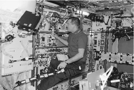 A scientist on the ISS conducts research in one of the stations labs. The results of space research have helped improve the quality of life on Earth.