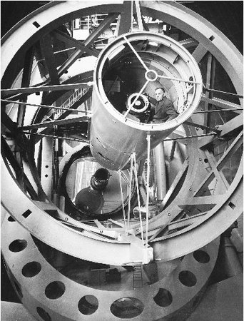 Edwin Hubble sits inside the telescope at the Mt. Palomar observatory. Palomars two-hundred-inch telescope is able to detect objects as far as 10 billion light-years away.