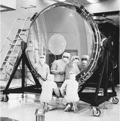 Researchers inspect the Hubble Space Telescope mirror. Construction of this massive mirror was a complex procedure that took nearly ten years to complete.