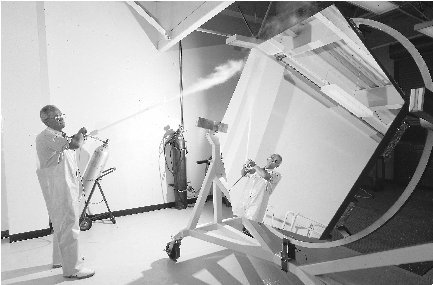 An astronomer cleans dust from one of Kecks hexagonal mirrors. Each of the two telescopes uses thirty-six of these mirror pieces.